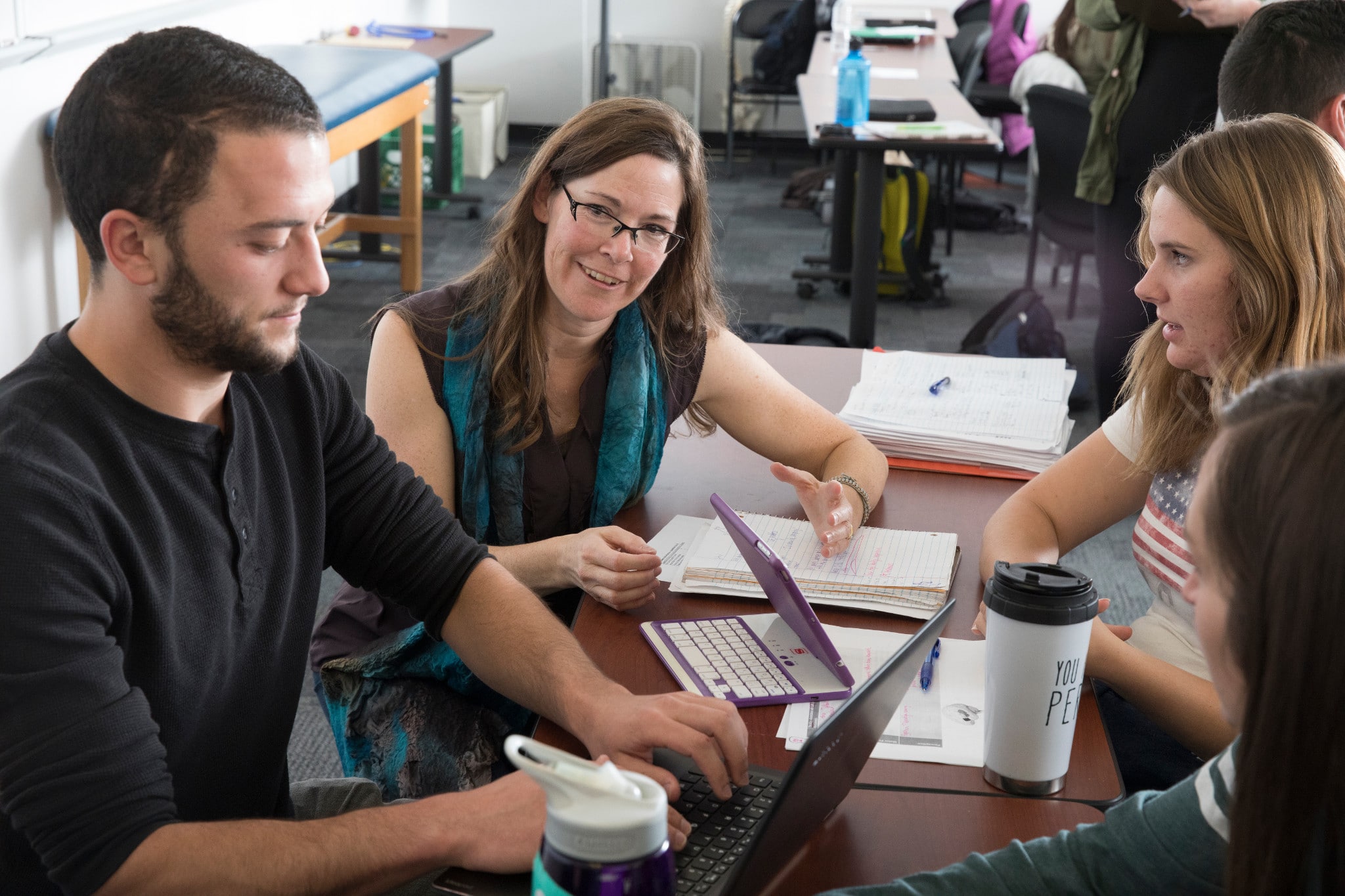 Students study together while sitting at a table.