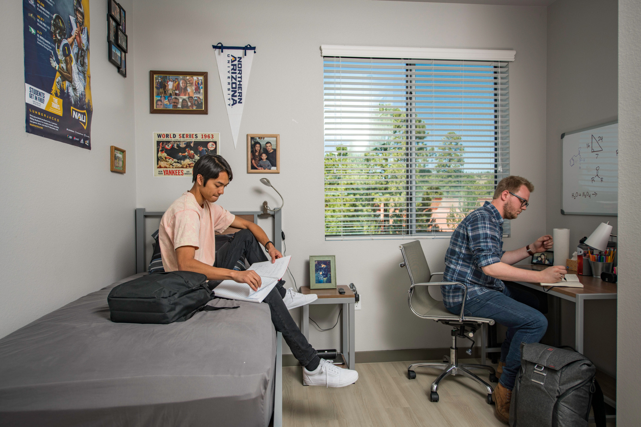 Two students studying in their dorm room.
