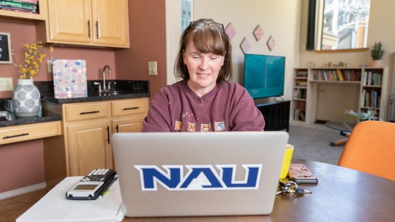 Student works on laptop at home.