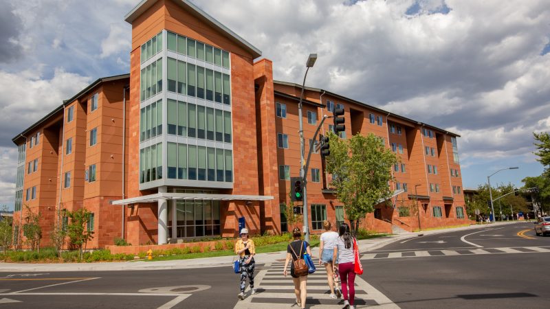 Students walk in crosswalk on NAU campus.