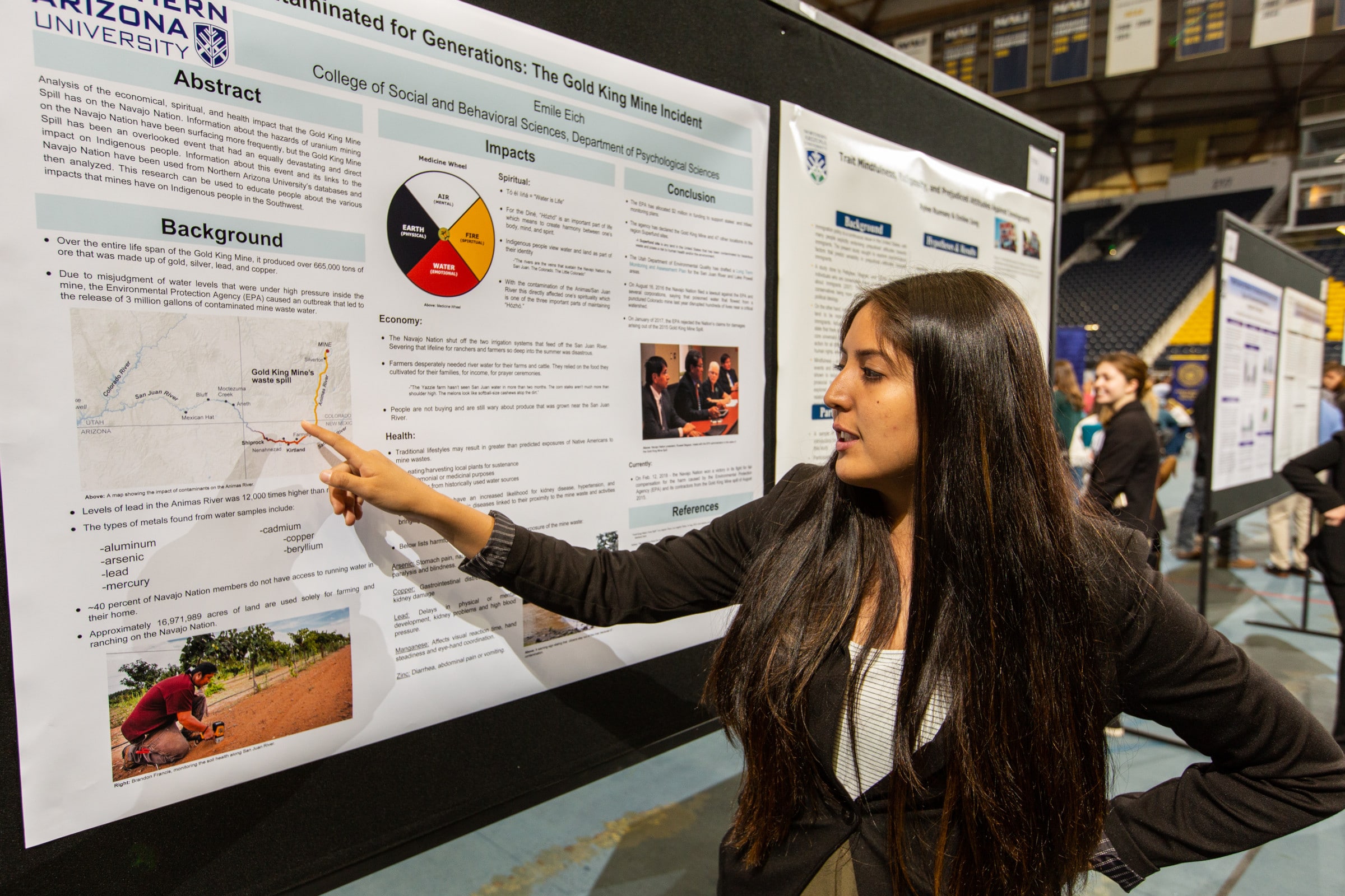 Student points to information on a poster.