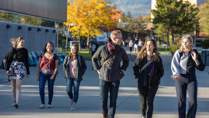 Students walking through NAU campus during fall.