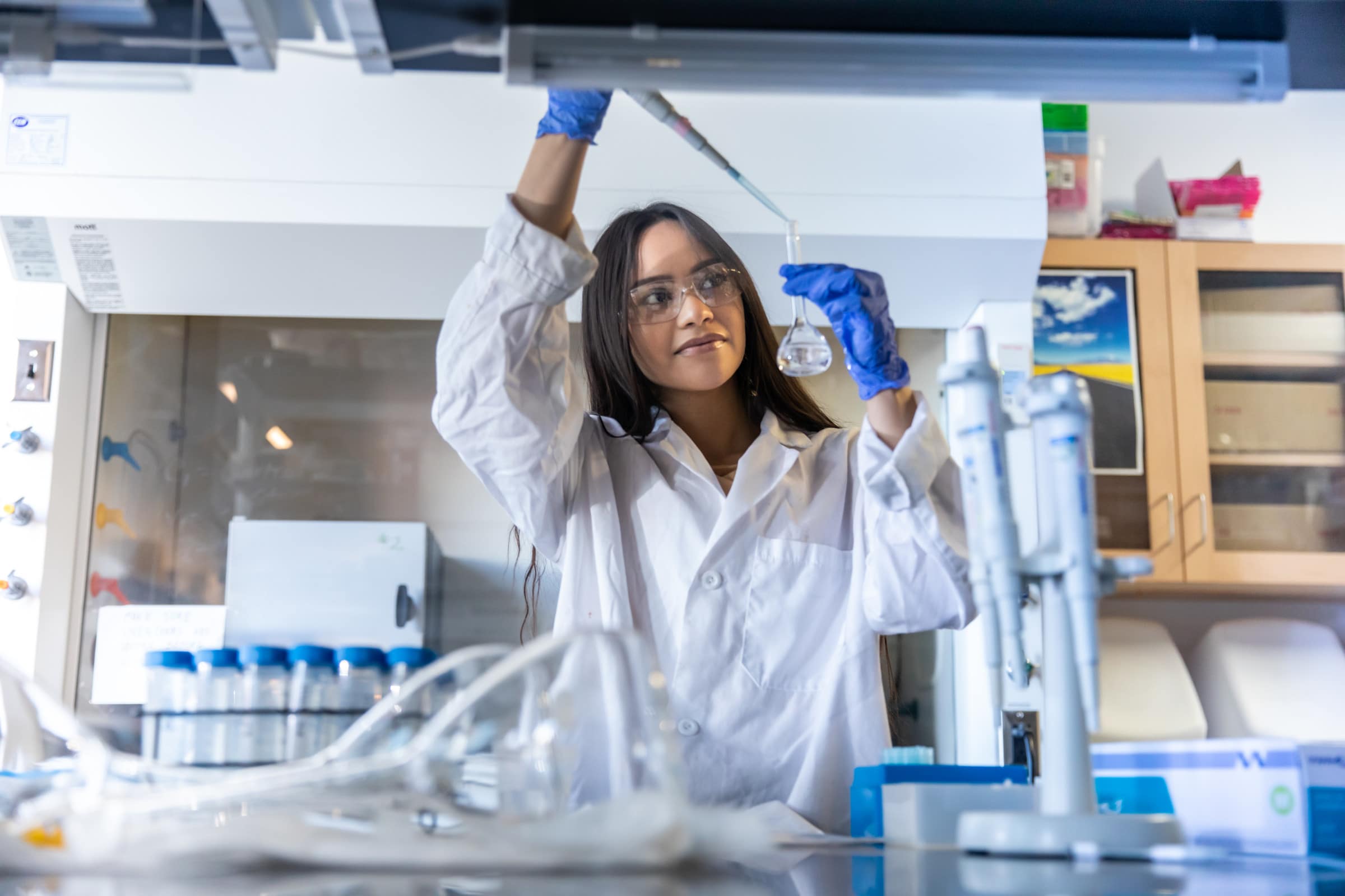 Student uses pipet to place material into a test tube.