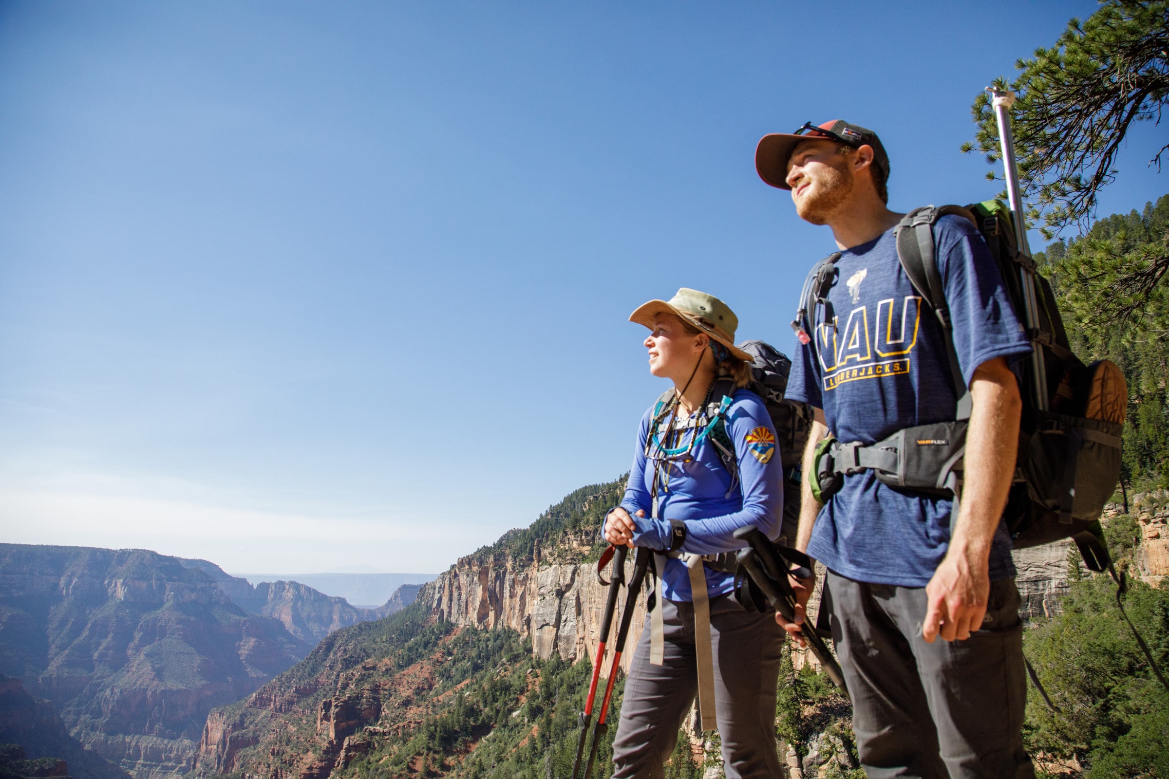 Students hiking look at a scenic view.