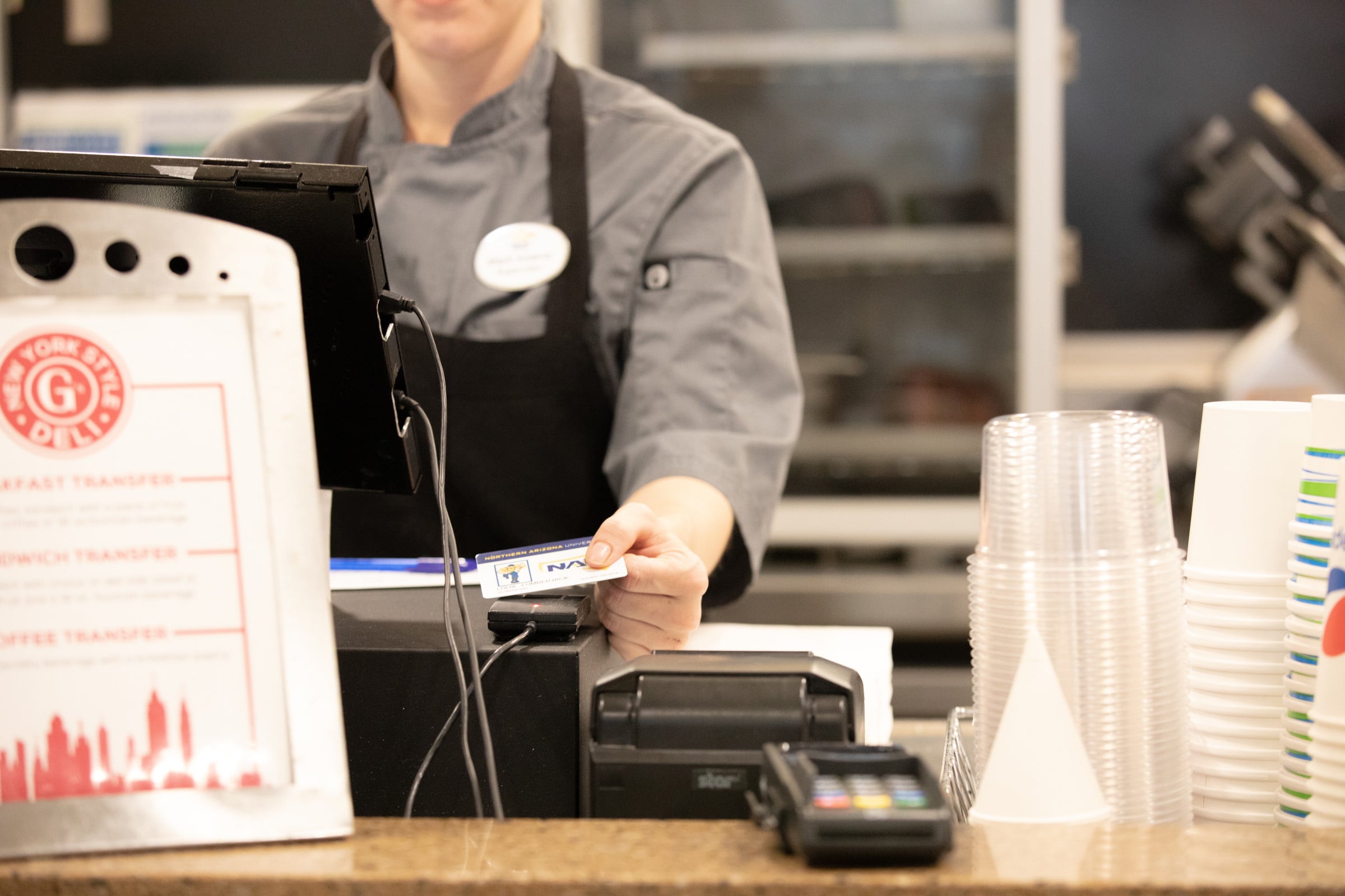 Campus dining cashier takes a payment.