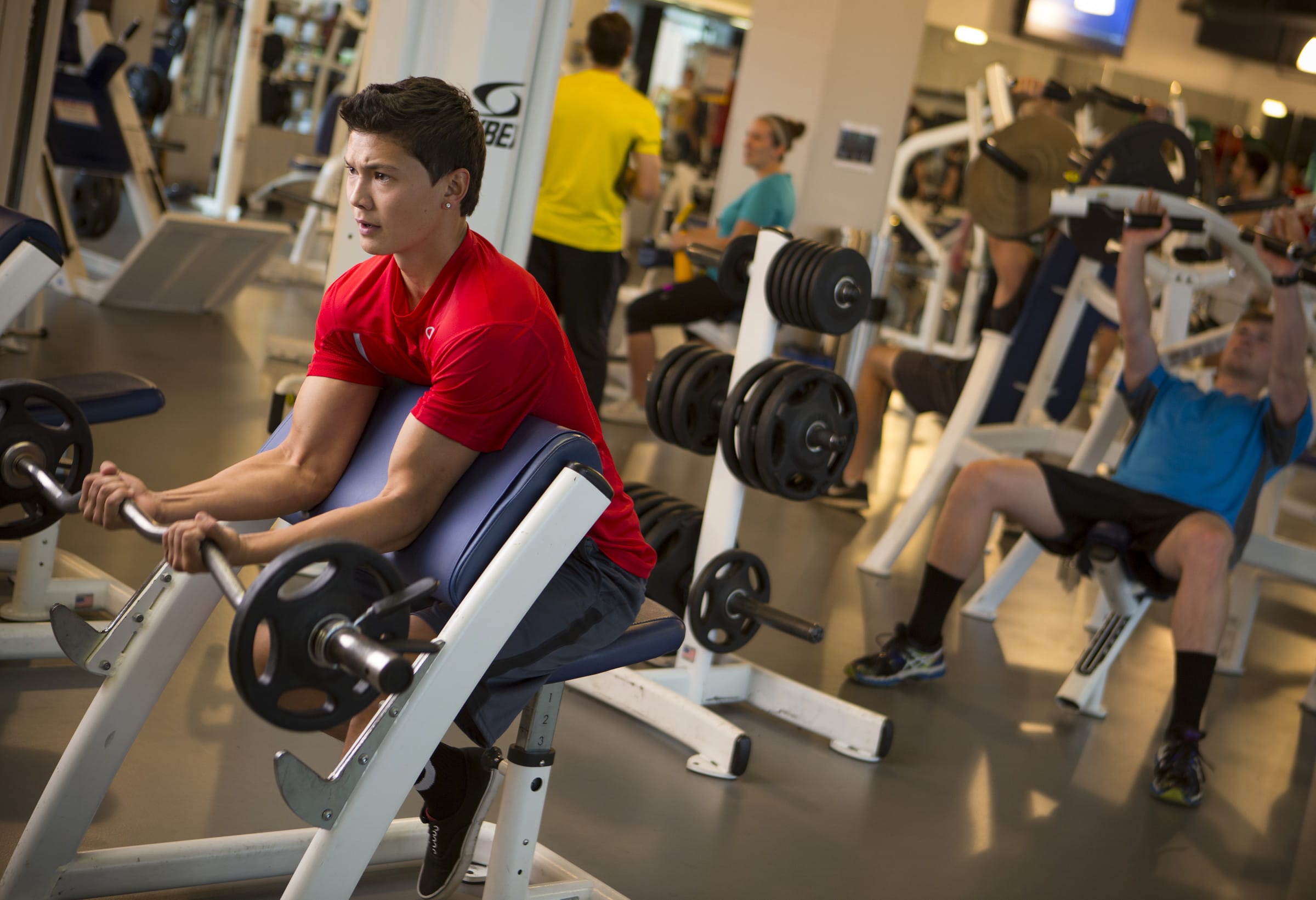 Student lifts weights at the gym.