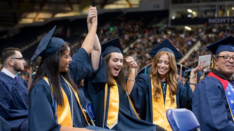 NAU student celebrate at graduation.