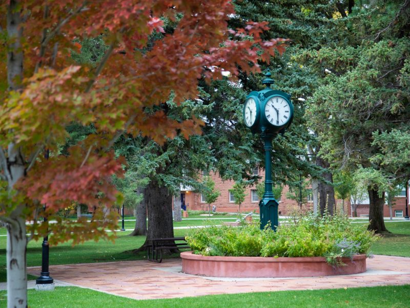 Trees with fall colors and classic clock at NAU mountain campus
