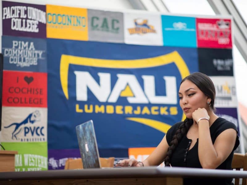 NAU student Sage Bond looks at her laptop.