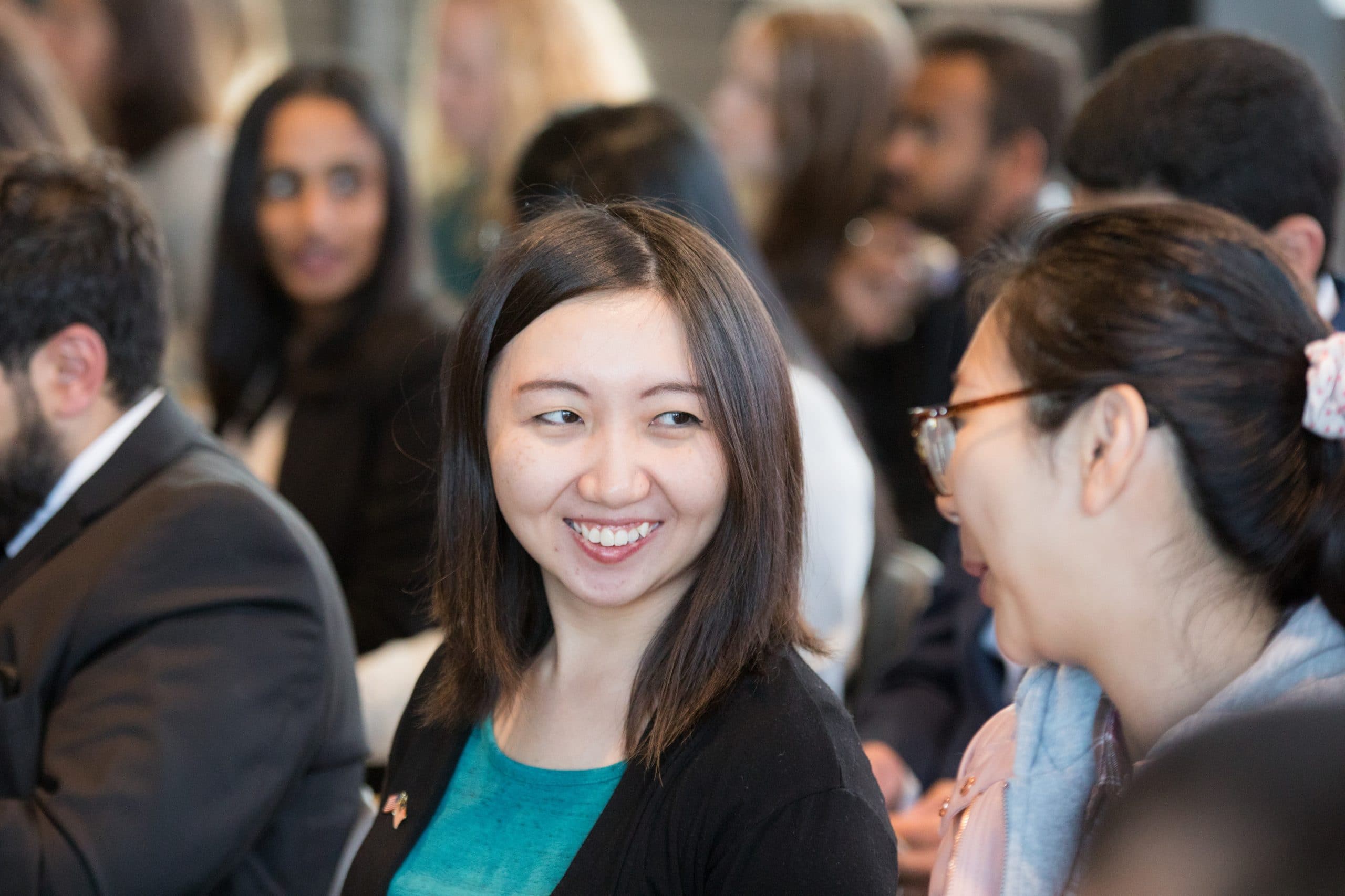 International students smiling and talking to each other at an International celebration.