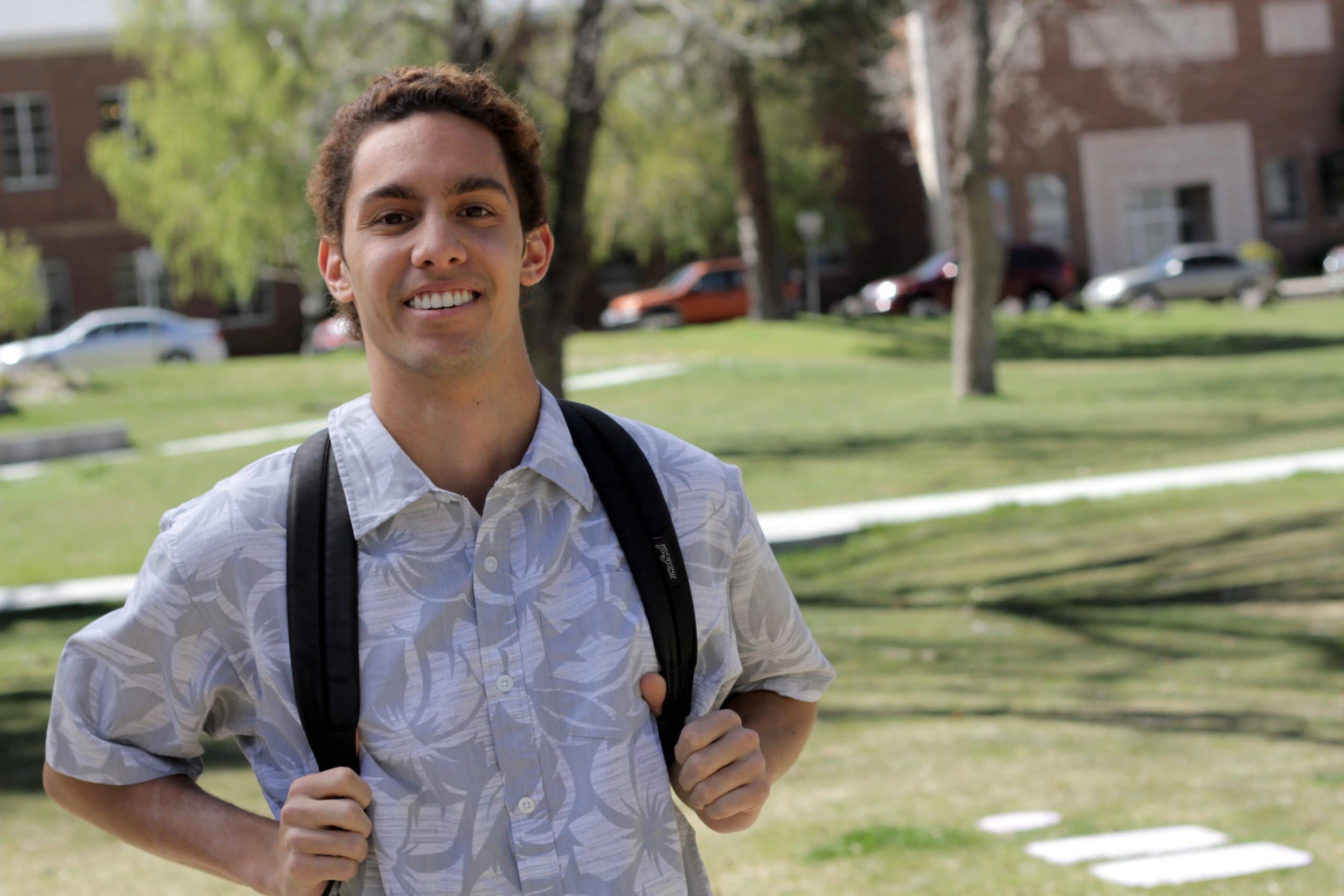Student walking outside with backpack on the Flagstaff campus.