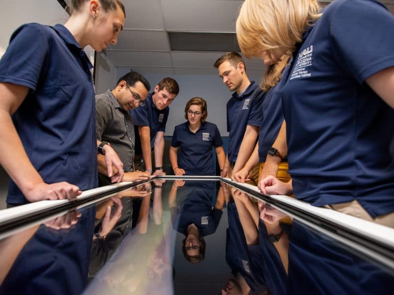 Physical therapy students looking at a large screen.