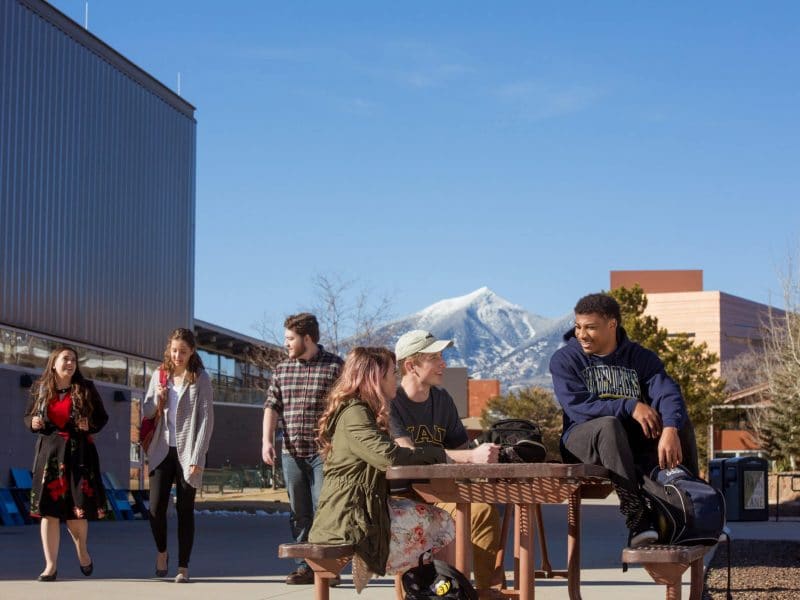 Students sit at picnic table at Flagstaff campus.