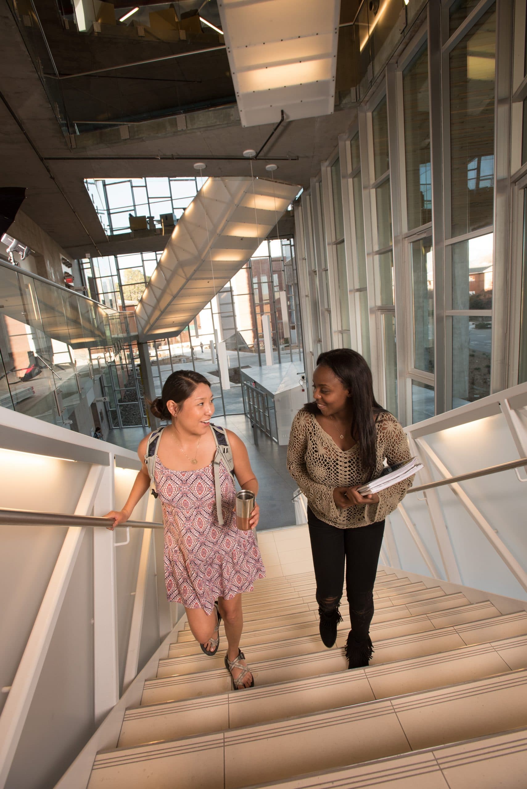 Two students going up stairs.