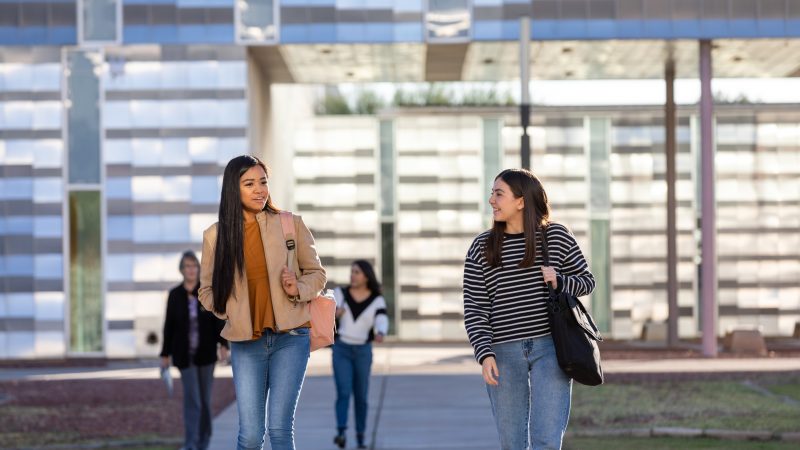 Two students walking from class at the N A U-Yuma campus.