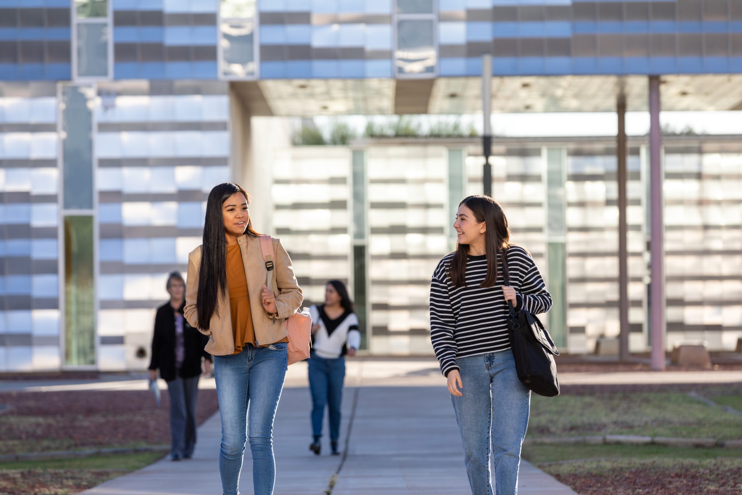 Two students walking from class at the N A U-Yuma campus.