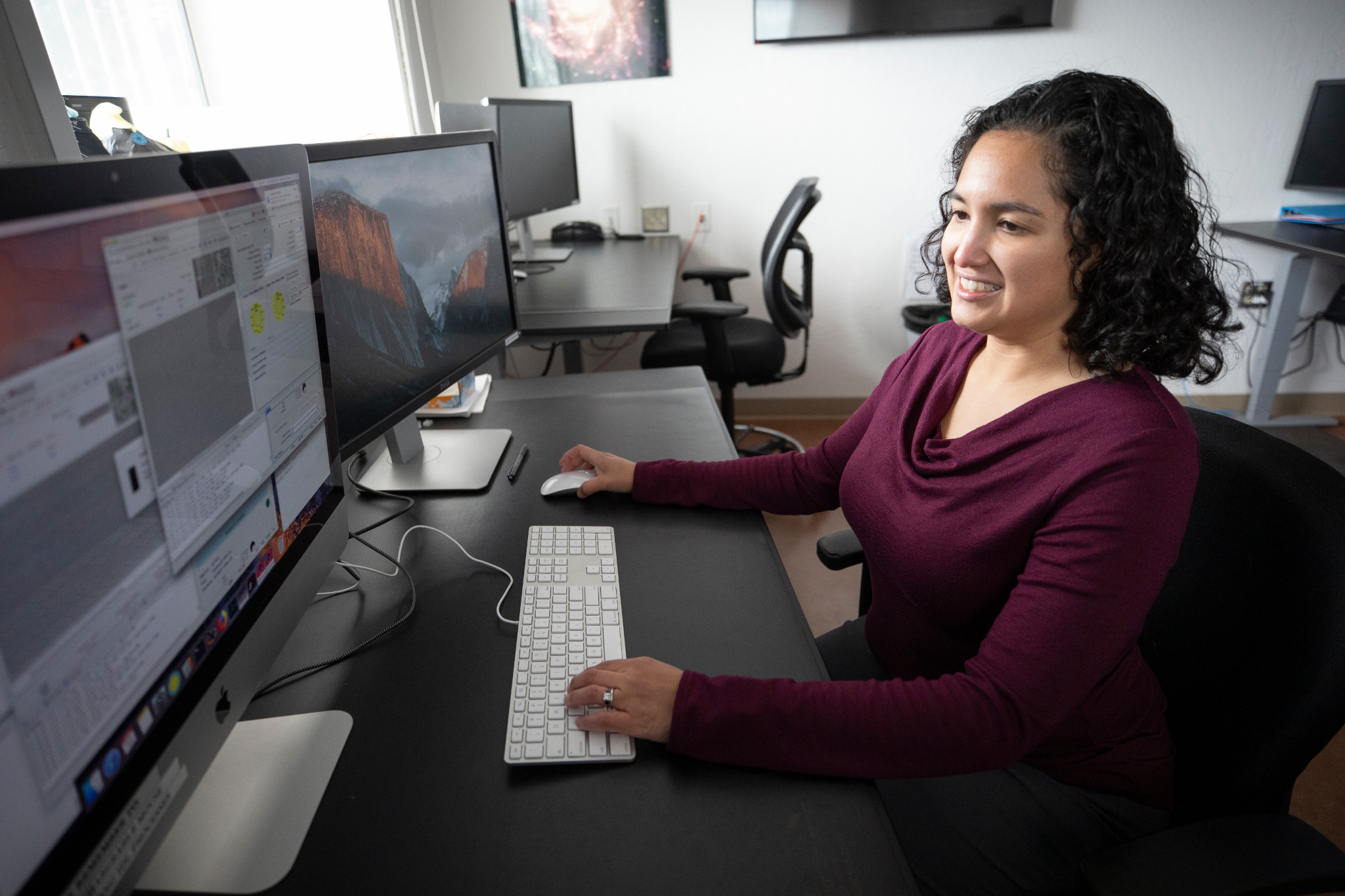 Faculty member working on a desktop.