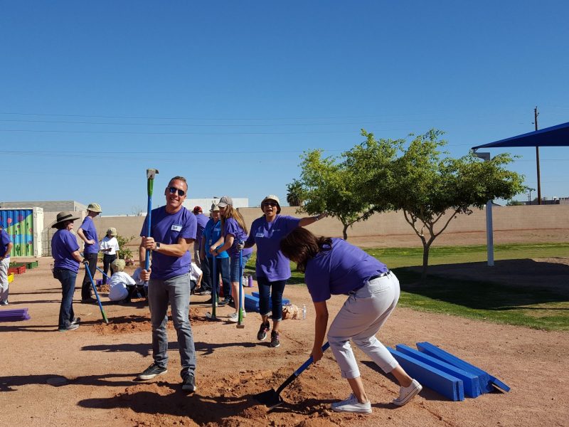 N A U alumnus Tad Gary helps break ground next to a park.