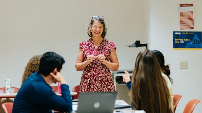 A teacher works with her students at N A U Yuma.
