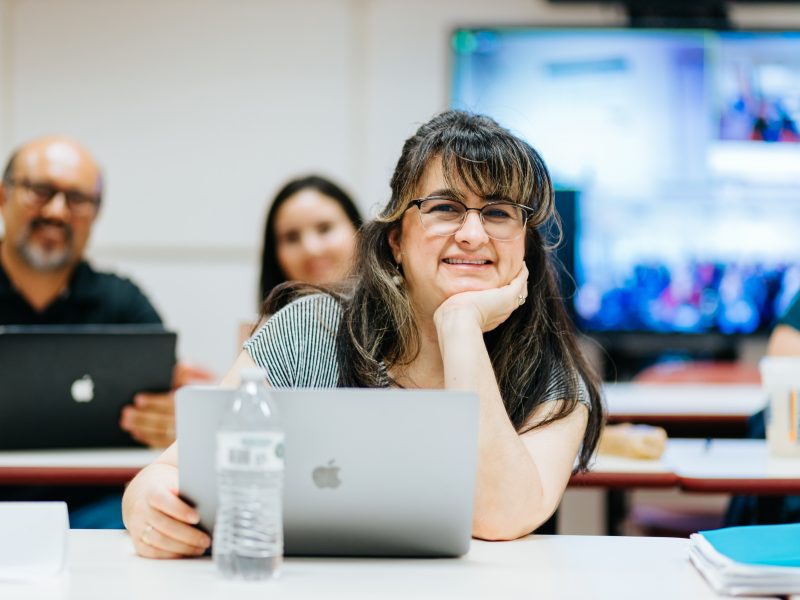 People smile in a N A U classroom.