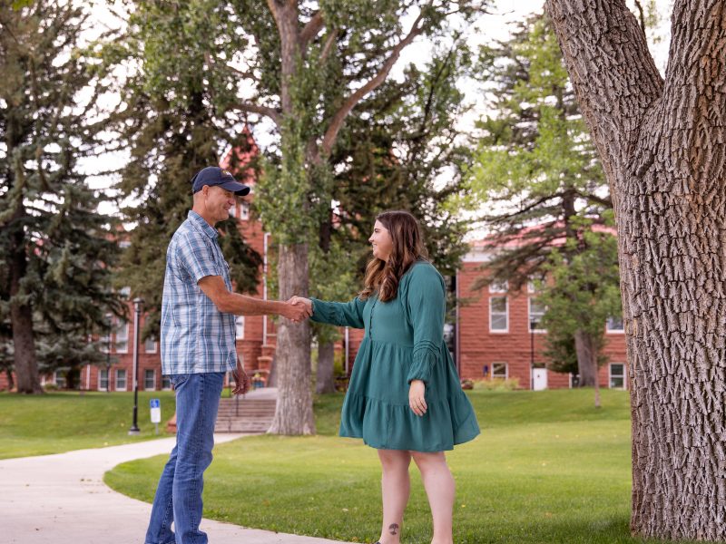 Two people shake hands at N A U.