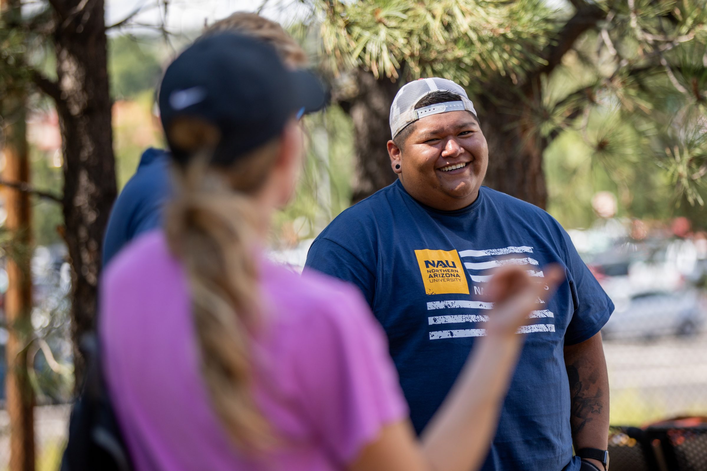 A student smiles while playing disc golf in Flagstaff.
