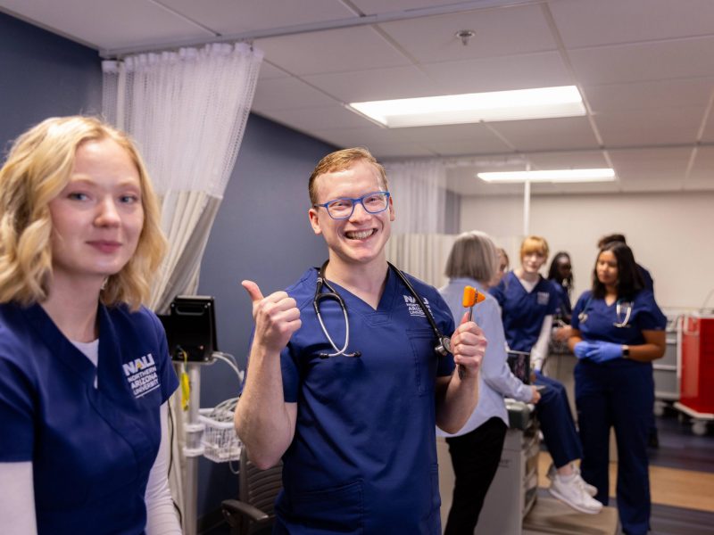 N A U nursing students smile while in class.