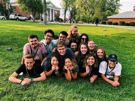 student group laying on grass