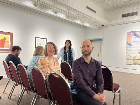 people smile at an event in an art museum