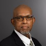 A photo of a man in a suit.
