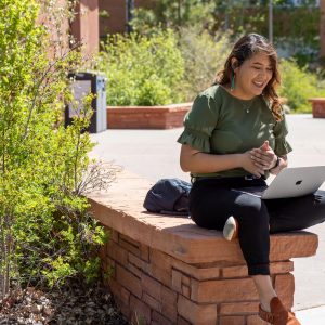 A student with a laptop at NAU campus.