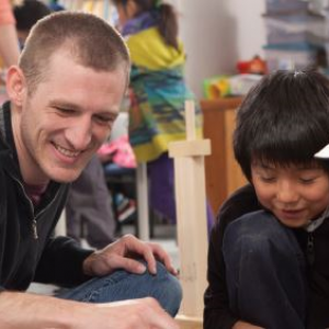 Teacher working with young student