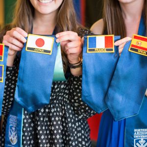 NAU students with patches of the places they studied abroad.