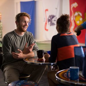 Two people chatting and drinking coffee.