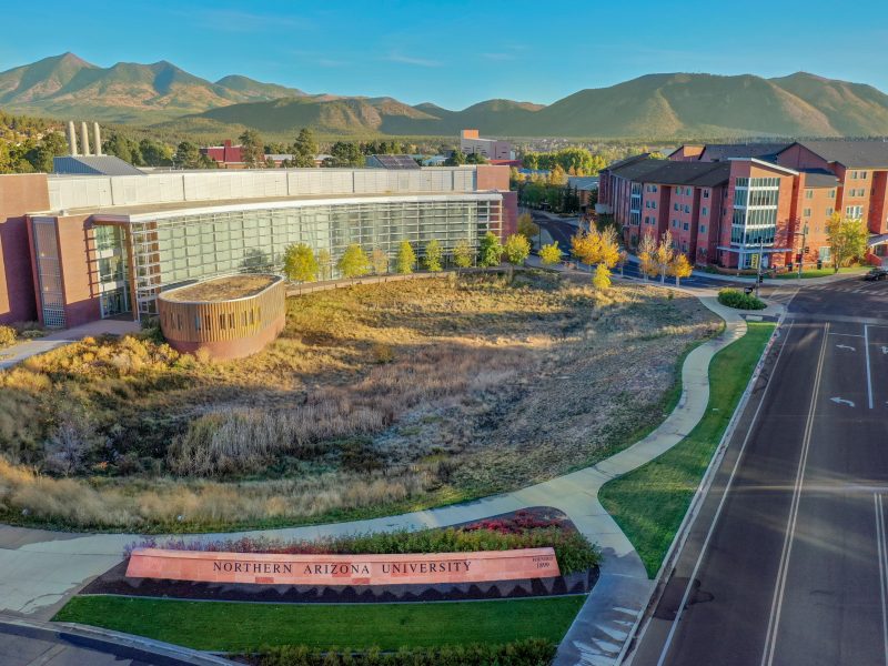 Aerial picture of N A U's Flagstaff campus with mountains in the distance.