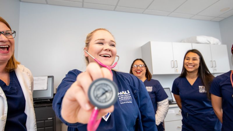 Nursing student holds her stethoscope close to the camera.