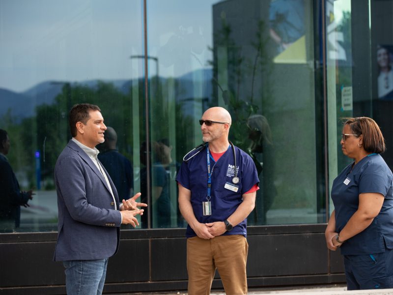 President Cruz Rivera speaks with staff outside of the N A U Health and Learning Center.