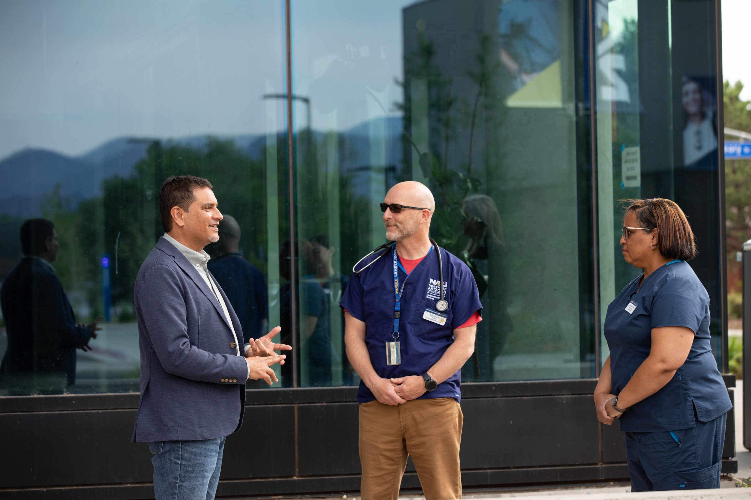 President Cruz Rivera speaks with staff outside of the N A U Health and Learning Center.