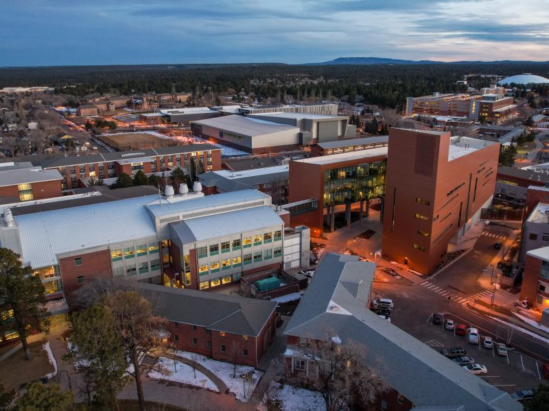 A drone photo of N A U Flagstaff campus at dusk.