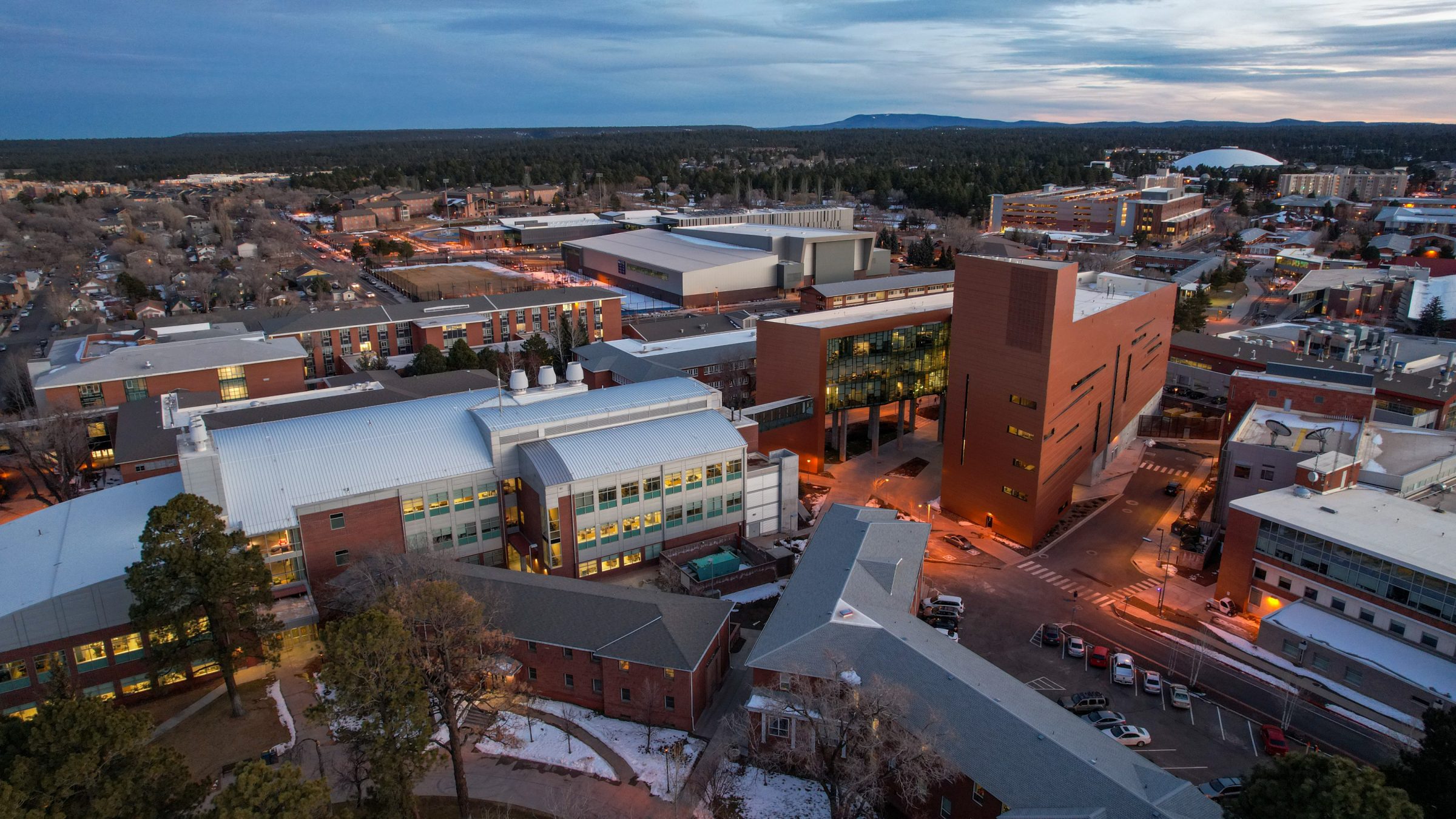 A drone photo of N A U Flagstaff campus at dusk.