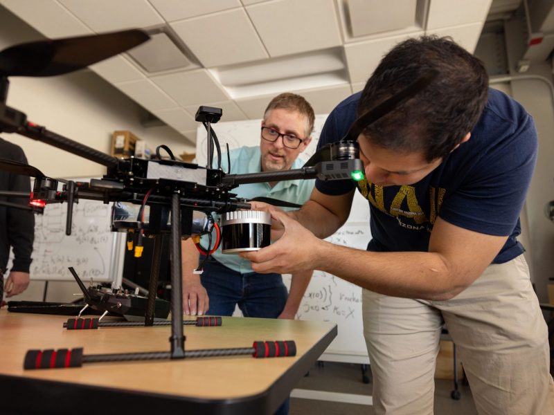 Students working on a drone in the S I C C S lab.
