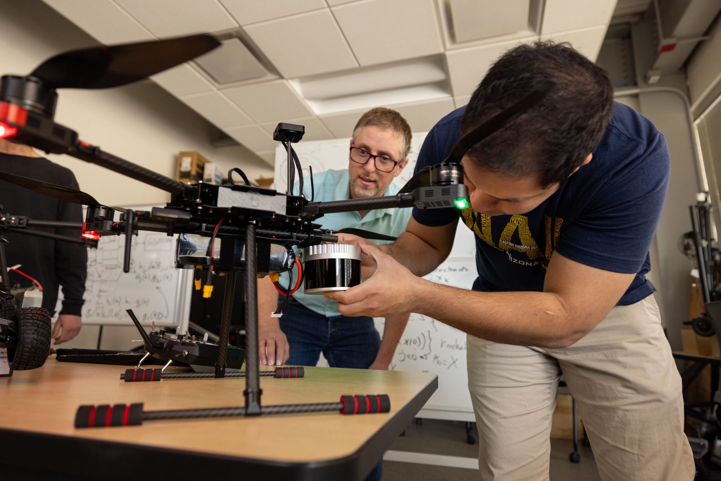 Students working on a drone in the S I C C S lab.