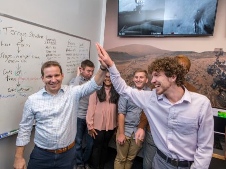 a professor and student high five in the NAU MARS lab