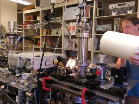 MS student pours liquid nitrogen in a dewar to prepare ices that resemble the surface of Pluto.