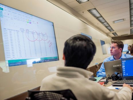 Student observing spreadsheet projected on whiteboard
