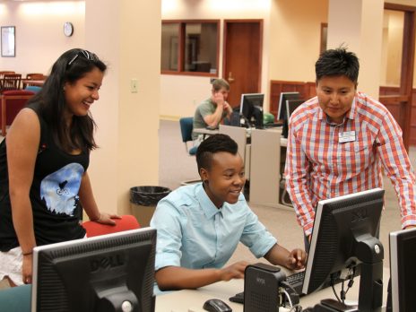three nau students working on a computer
