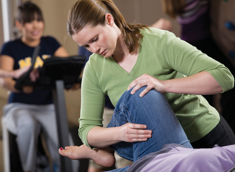 NAU PT student stretching a patients knee at the Phoenix Bioscience Core.