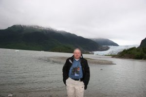 photo of man standing in front of a lake