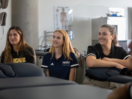 Athletic trainers sitting and listening to a lesson.