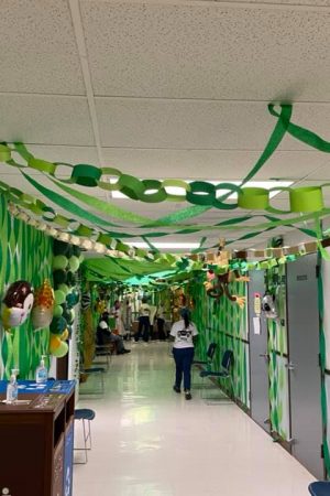 A decorated hallway with green streamers.
